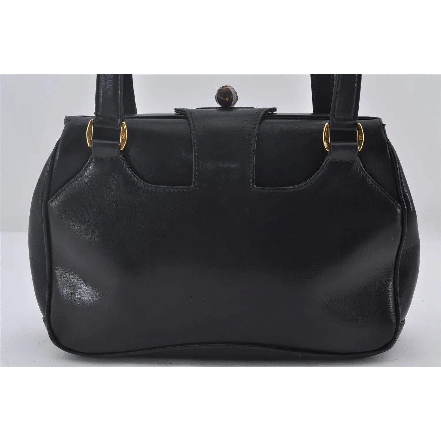Mod Gucci, black leather shoulder bag with two longer straps, two exterior pockets, a hinged opening, and a gold and bamboo accent clasp